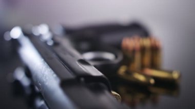 9mm gun rotating on a reflective surface