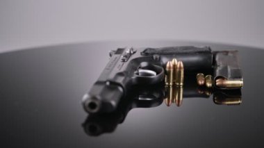 9mm gun rotating on a reflective surface
