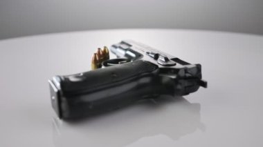 9mm gun rotating on a reflective surface