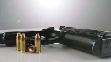 9mm gun rotating on a reflective surface