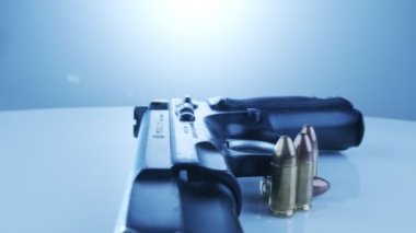 9mm gun rotating on a reflective surface