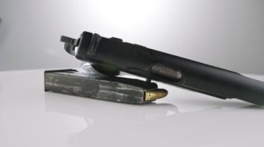 9mm gun rotating on a reflective surface