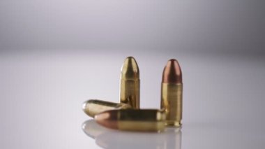 9mm gun rotating on a reflective surface