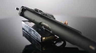 9mm gun rotating on a reflective surface