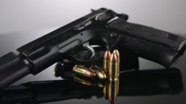9mm gun rotating on a reflective surface
