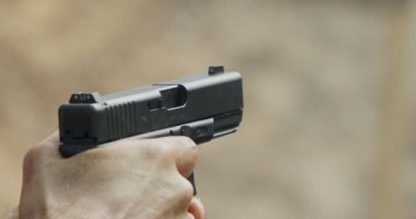 Pistol shooting bullets in slow motion footage. Hand guns in shooting range