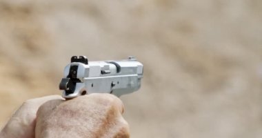 Pistol shooting bullets in slow motion footage. Hand guns in shooting range