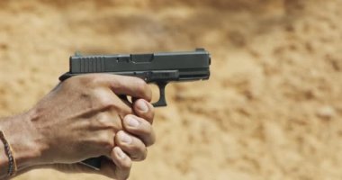 Pistol shooting bullets in slow motion footage. Hand guns in shooting range