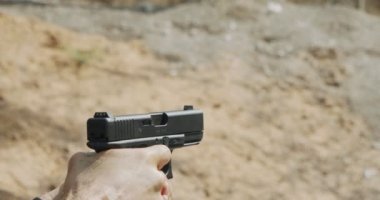 Pistol shooting bullets in slow motion footage. Hand guns in shooting range