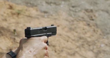 Pistol shooting bullets in slow motion footage. Hand guns in shooting range