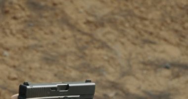 Pistol shooting bullets in slow motion footage. Hand guns in shooting range