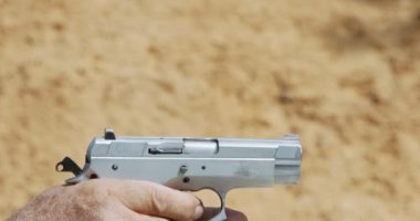 Pistol shooting bullets in slow motion footage. Hand guns in shooting range