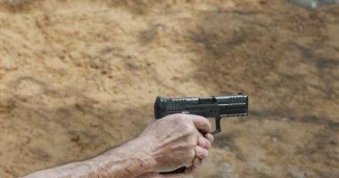 Pistol shooting bullets in slow motion footage. Hand guns in shooting range