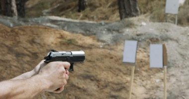 Pistol shooting bullets in slow motion footage. Hand guns in shooting range