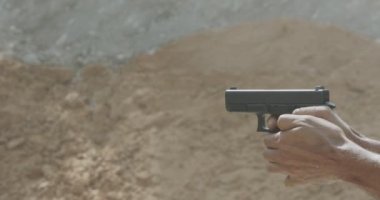 Pistol shooting bullets in slow motion footage. Hand guns in shooting range