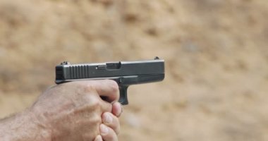 hand gun firing with cartridge flying away