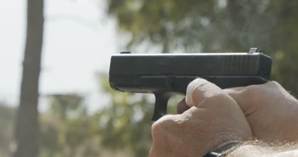 Slow Motion Hand Gun Firing Cartridge Flying Away — Wideo stockowe