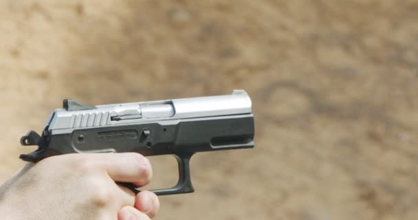 Hand Gun Firing Cartridge Flying Away — Wideo stockowe