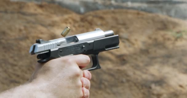 Hand Gun Firing Cartridge Flying Away — Stockvideo