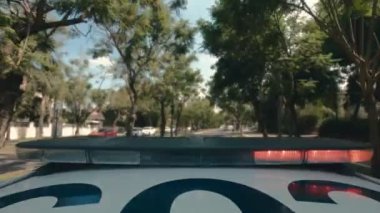 Şehrin sokaklarında mavi ve kırmızı ışıklarla giden polis arabasının zamanı.