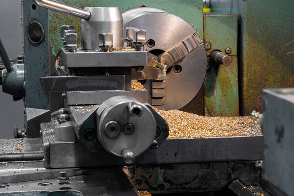 Making nuts from a bronze hexagon on a lathe.