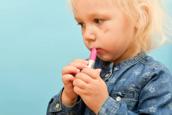 Little Blond Girl Child Paints Lips Mom Red Lipstick Children — стоковое фото