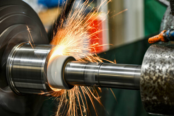 Sparks from the grinding wheel during internal grinding on a cylindrical grinding machine.