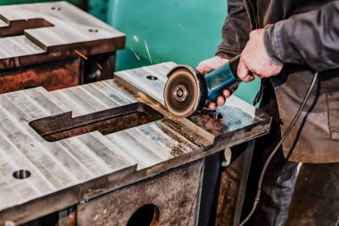 Grinding burrs and metal with an angle grinder with sparks