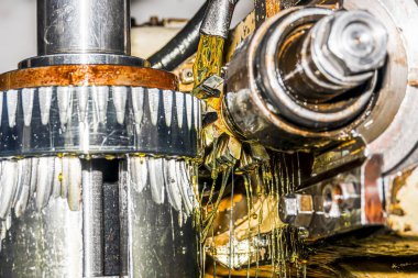 Yağ soğutmalı bir dişli kesme makinesi dişli tekerleğinde sarmal kesiyor..