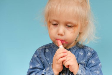 Küçük bir çocuk anne babasından gizlice annenin kozmetik ürünlerini kullanıyor..