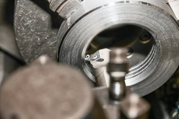 Threading on the inside of the nut inside with a threaded cutter.