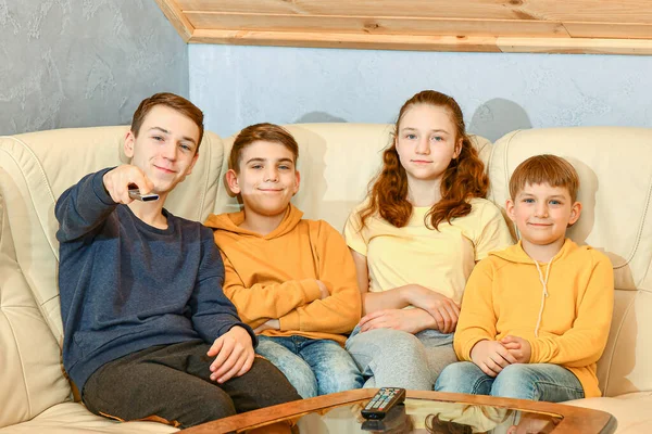 Quatre Enfants Avec Télécommande Assoient Sur Canapé Cuir Jaune Côté — Photo