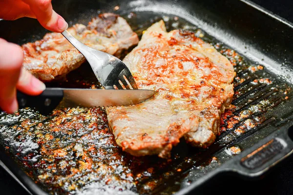 Woman Cuts Fried Pork Steaks Pan Knife Fork — Stock Photo, Image