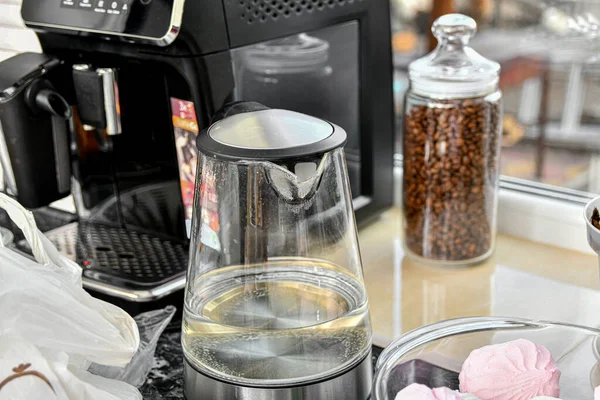 Glass kettle with water for coffee in the kitchen.