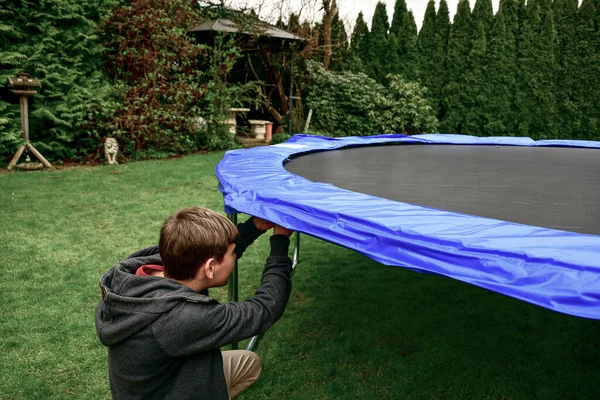 Boy Assembles New Trampoline Stretches Springs Jump — 图库照片