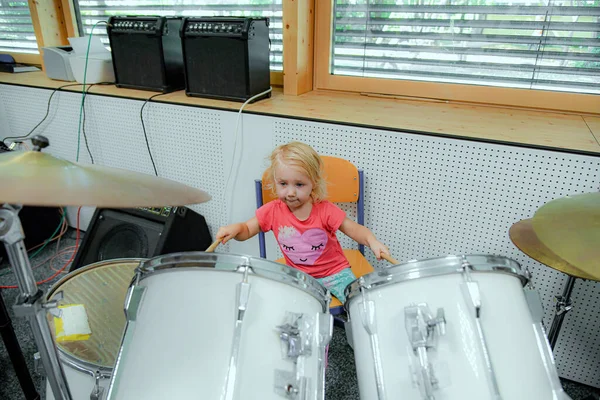 Little Girl Tries Play Drum Kit Music School — Stock Fotó