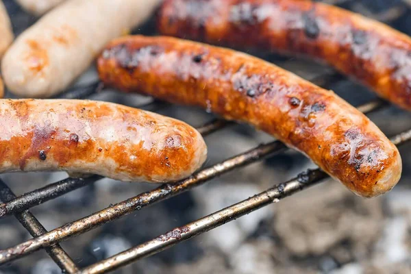 Grilled sausages on the fire are on the grill and are ready to eat.