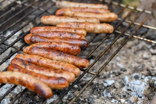 Grilled sausages on the fire are on the grill and are ready to eat.