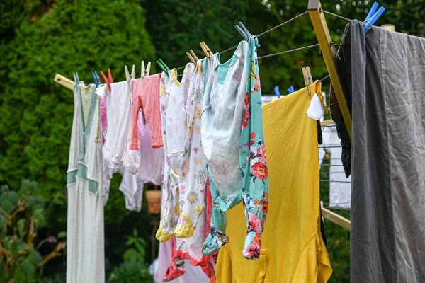 Children\'s things after washing hang on a rope in the yard.