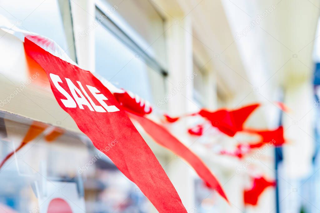 Selective focus, sale bunting displayed outside a shop, concept