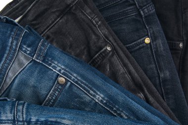 Beyaz arka planda kot pantolon desenli mavi kot pantolonların çeşitli tonlarında. Tasarım için Denim arkaplan dokusu. Kumaş kumaş. Arkaplan olarak kullanılabilen mavi kot.
