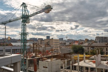 Construction site with heavy construction machinery in metropolis captured during the early stage of mega construction project. Tower crane at construction site. 