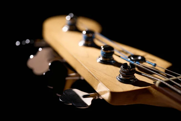 Metallic volume treble guitar bass knobs. Electric guitar. Red electric bass guitar close-up. Musical instrument. Music. Four strings. Grif.