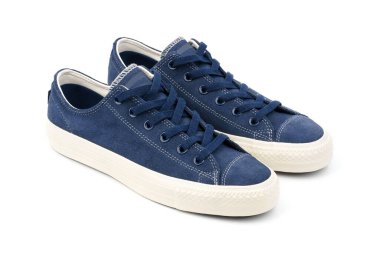 Blue sneakers on a colored background with copy space. Youth shoes. Keds.