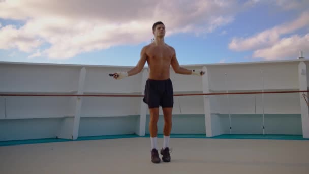 Sportive attractive naked torso man jumps rope outdoor cruise ship deck exercising workout — Stock Video