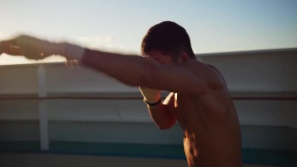 Athletic young man with naked torso exercising shadow boxing outdoors — Stok Video