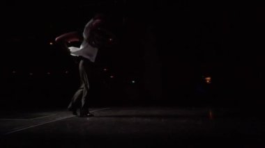 Male dancer holds woman in dance support on shoulders,lateral lift,her leg bent at knee down,spinning around.360-degree camera flyby dancing couple in slow motion.Clothes,hair romantically fluttering