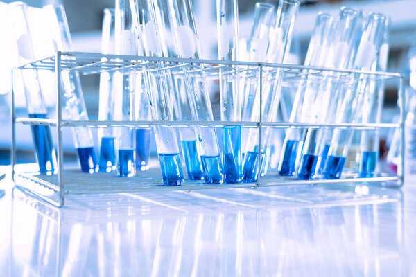 glass flask in chemical science education laboratory with molecular structure in blue background