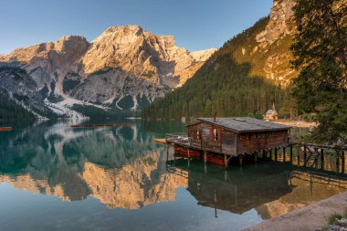 Amazing Sunrise view of Lago di Braies (Pragser Wildsee) with Wooden boats, one of the most beautiful lake in South Tirol, Dolomites mountains, Italy. Popular tourist attraction.