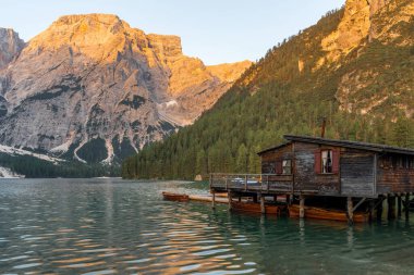 Amazing Sunrise view of Lago di Braies (Pragser Wildsee) with Wooden boats, one of the most beautiful lake in South Tirol, Dolomites mountains, Italy. Popular tourist attraction.